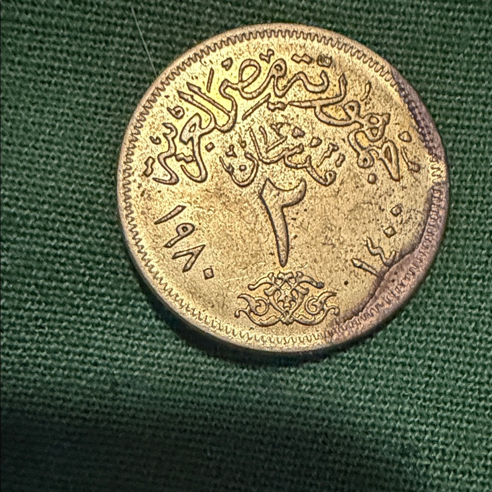 Mint Gold-Tone Coin on Green